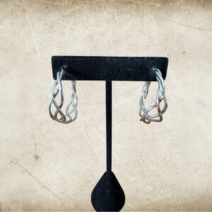 Pair of silver colored metal twisted hoop earrings
NWOT. Shiny cute earrings.